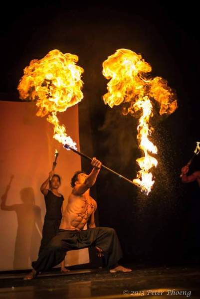 Phare Circus fire act - artist with fire baton