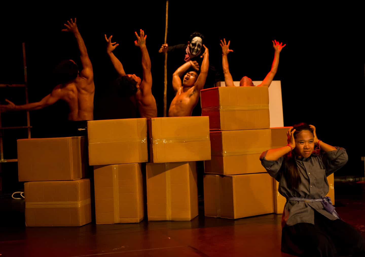 "Sokha" artists performing Khmer Rouge scene symbolically with boxes