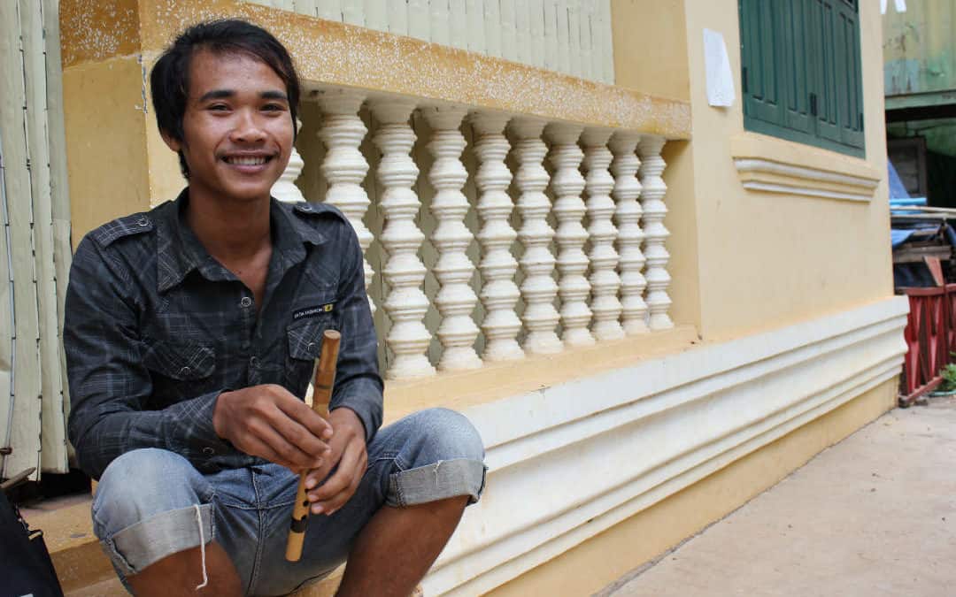 Makara Ly - music student at Phare Ponleu Selpak poses with a wooden flute
