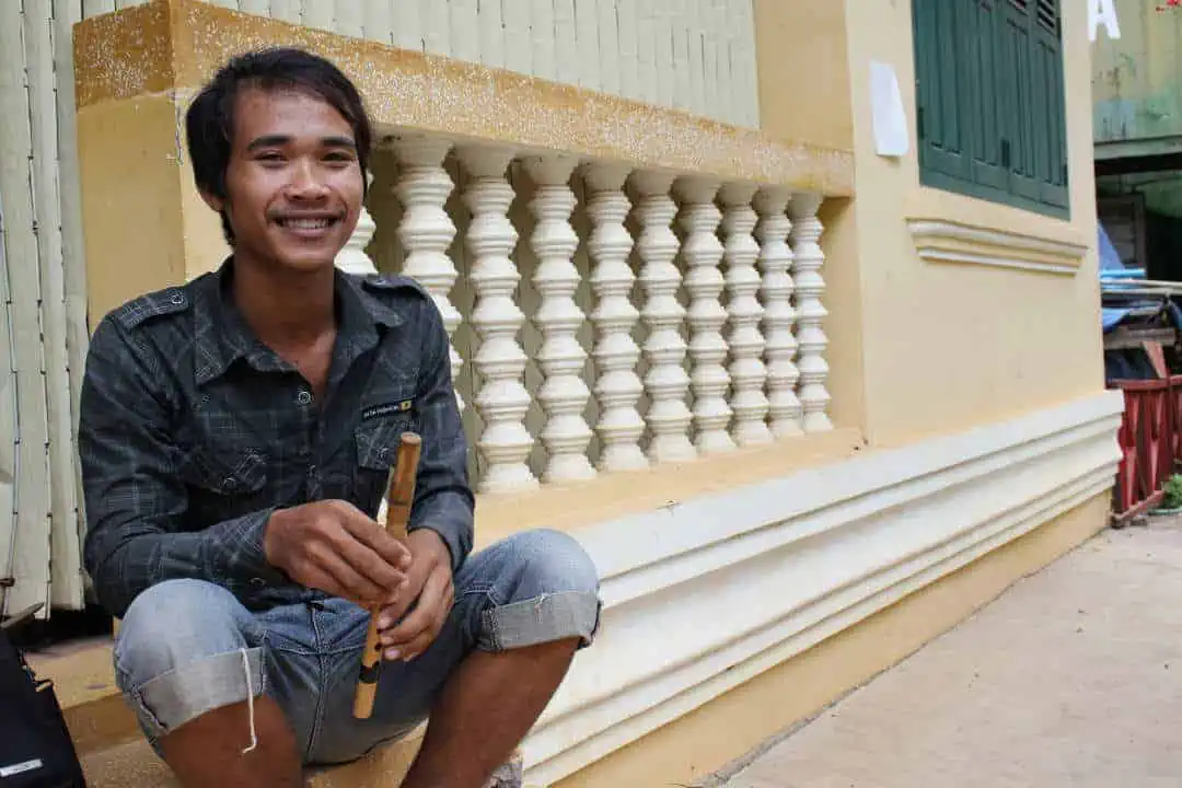Makara Ly - music student at Phare Ponleu Selpak poses with a wooden flute