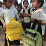 Education in Cambodia - students receive backpacks at school