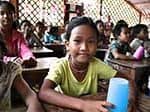 Education in Cambodia - student in classroom smiles for the camera