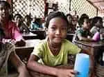 Education in Cambodia - student in classroom smiles for the camera