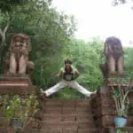 Makara Ly - Phare Circus musician - poses between lion statues