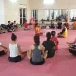 Phare Circus performers sit in a circle meditating