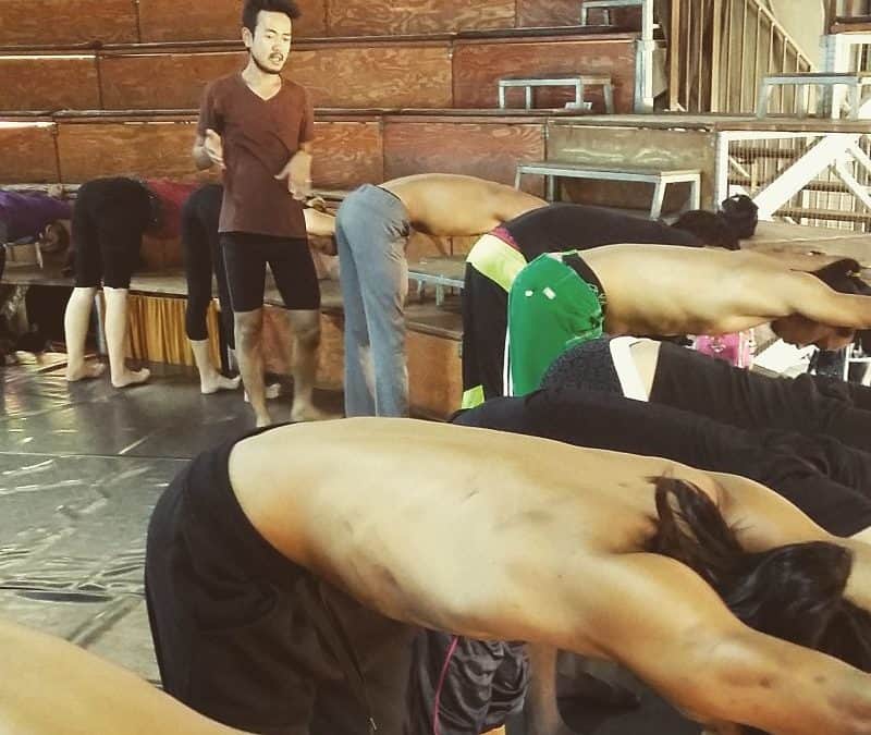 Phare Circus performers stretching and training on the big top stage