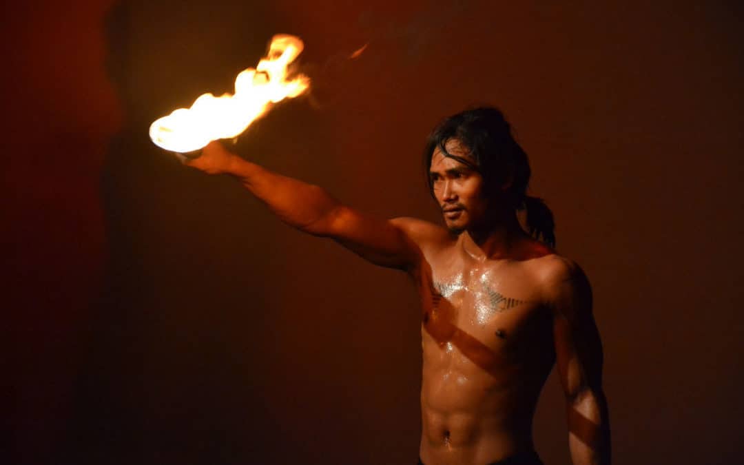 Phare Circus performer holding fire baton in the show "Eclipse"