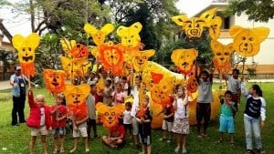 Young students display masks made for the Giant Puppet Parade , Siem Reap