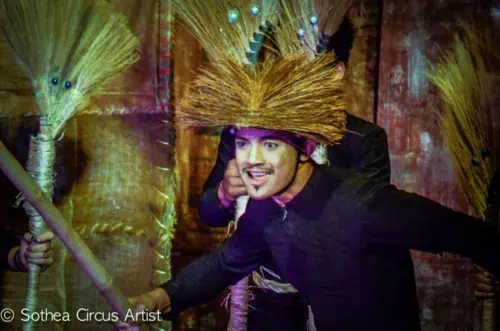 Phare Circus performer Mann Nem - man on stage in black costume and straw headdress