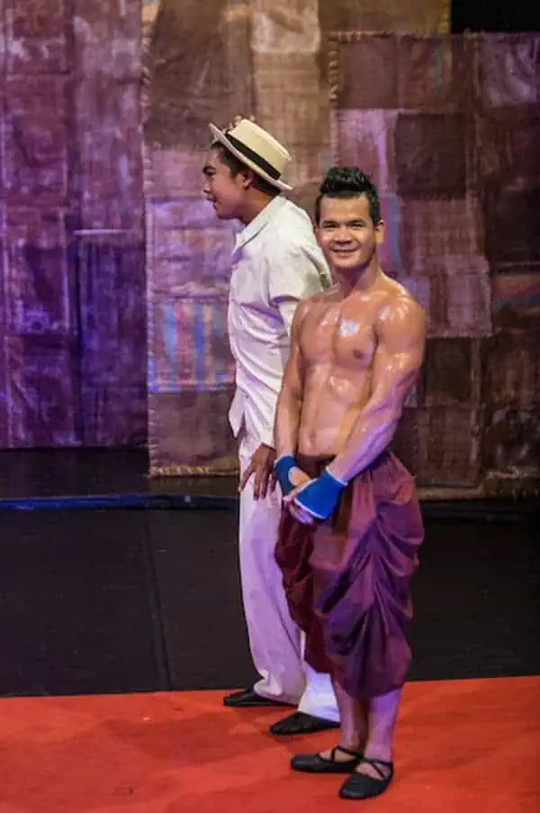 Phare Circus live show "Influence" - smiling male artist in red Khmer pants