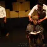 Phare Circus live show "Sokha" - man removes glasses of sitting old female teacher in Khmer clothes