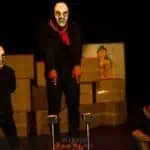 Phare Circus live show "Sokha" Cambodian Symbolism- balance sticks - 3 men in black costume, red Krama and skull masks