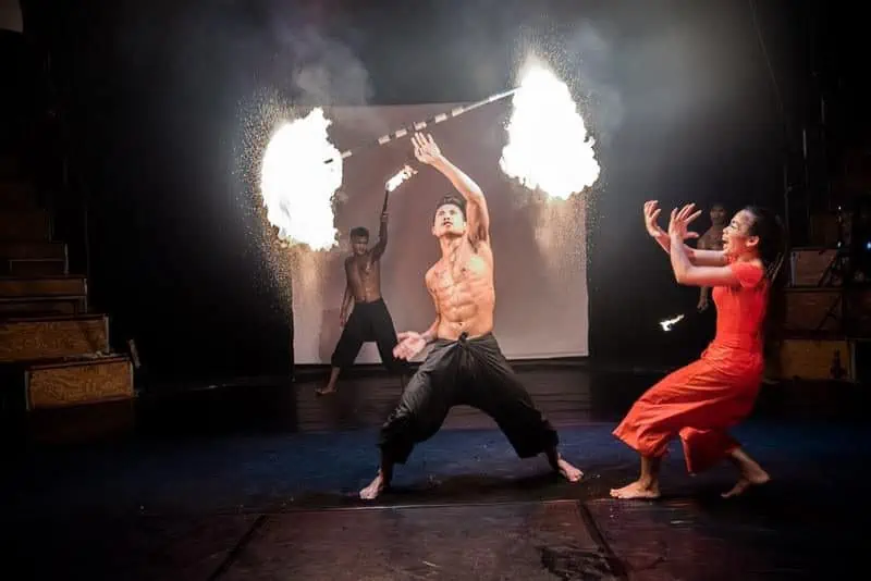 Phare Circus live performance "Eclipse" - man performing with fire baton, woman afraid of fire