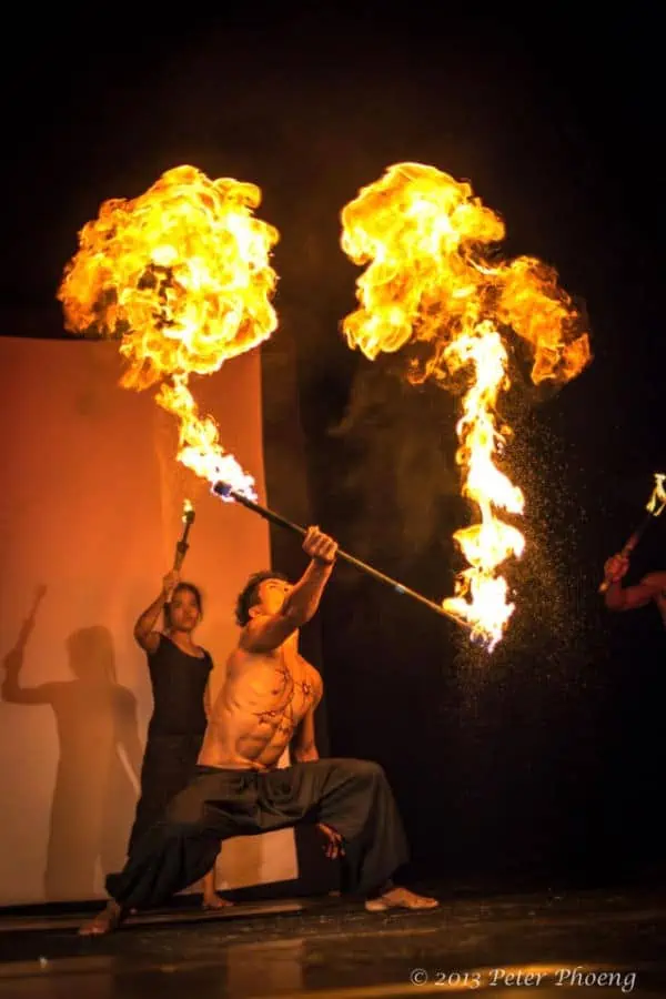 Phare Circus artist doing fire baton in live performance