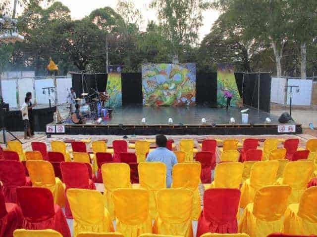 Phare Circus outdoor stage for inaugural Siem Reap performance, yellow and red satin covered chairs for guests