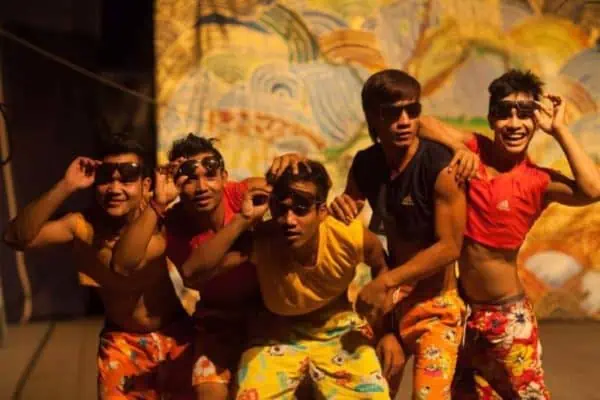 Phare Circus show "Putho": men in beachware peeking under their sunglasses