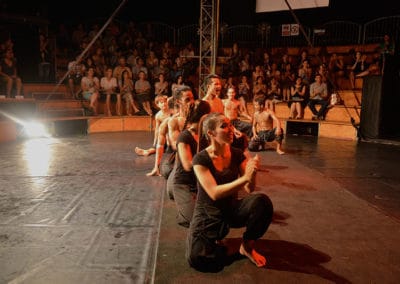Phare Circus performance "Eclipse": performers kneeling on stage watching another off camera