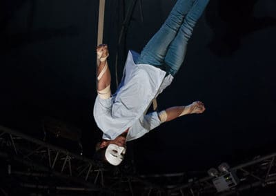 Phare Circus show "Same Same But Different": male performer inverted on aerial straps above stage