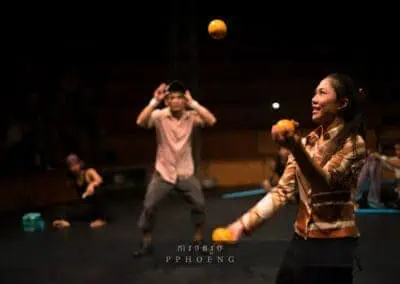 Phare Circus performance "The Adventure": female performer juggles while others look on
