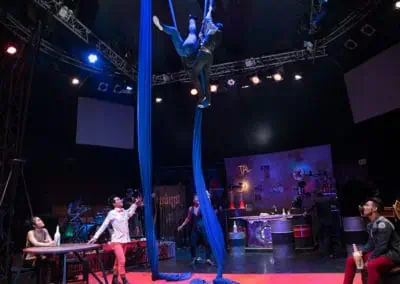 Phare Circus show "Khmer Metal": aerial silk performers above the stage with bar patrons watching