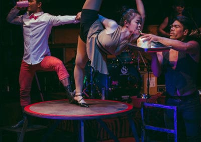 Phare Circus show "Khmer Metal": cortionist and dancer drink from coconuts while performing