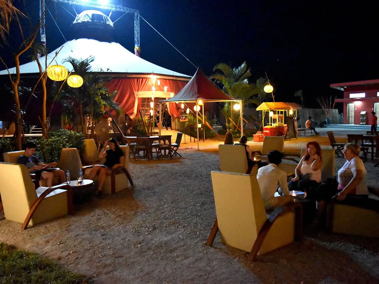 Siem Reap nightlife, dining and drinks at Phare Circus Cafe - guests seated in lounge chairs under colorfully lit iconic red circus big top