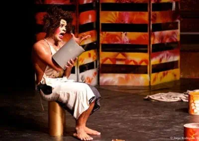 Phare Circus performance "Tchamlaek": clown with silly facial expression playing with rolla bolla equipment
