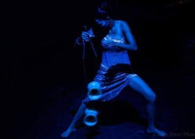 Phare Circus show "Tchamlaek": female dancer in dark blue lighting performing Diabolo