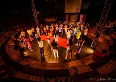 Phare Circus - circus arts workshop - students listening to teacher on circular big top stage