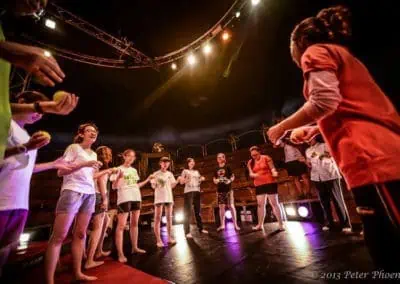 Phare Circus - circus arts workshop - teacher demonstrating juggling to students in the big top