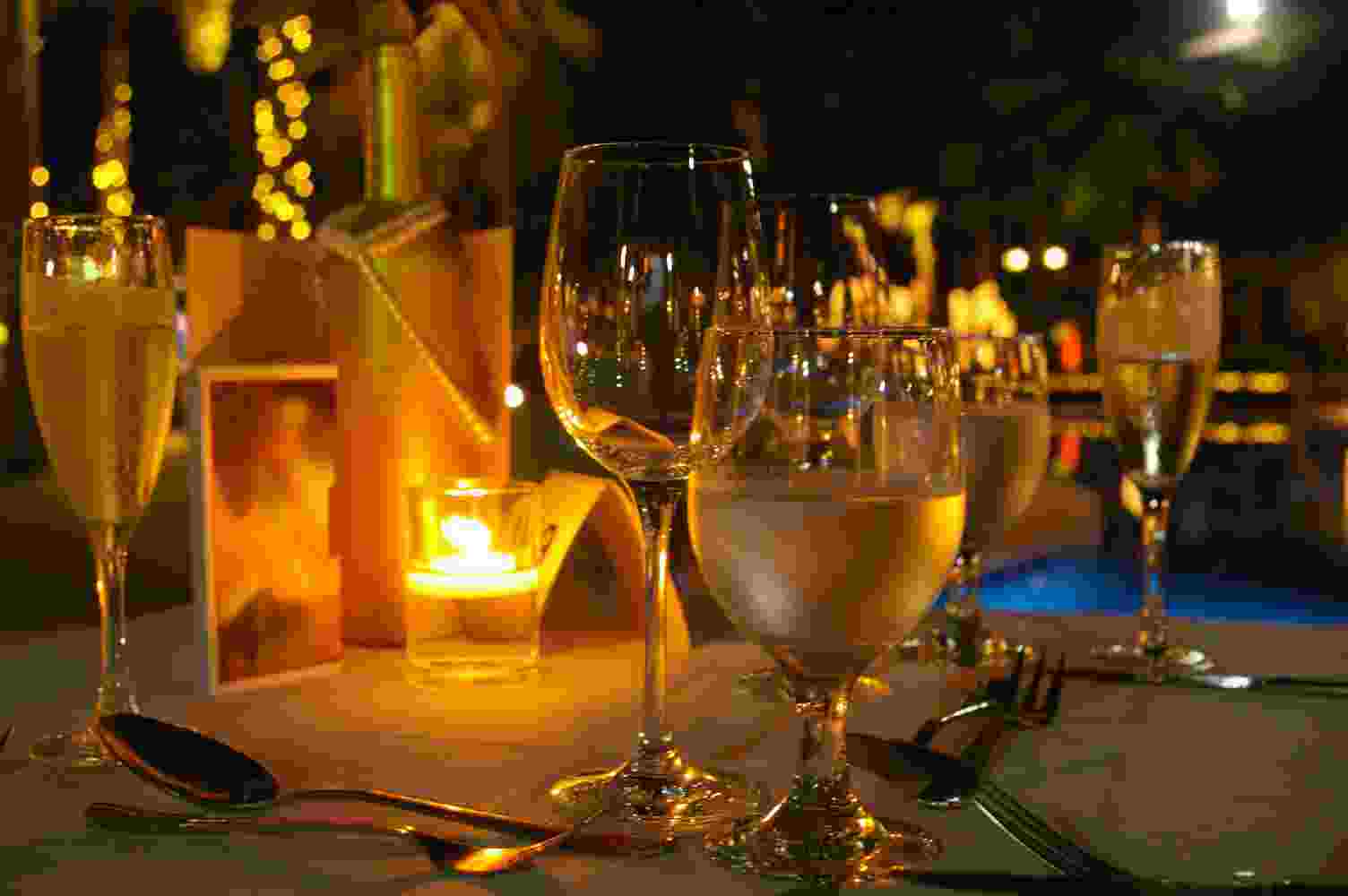 Phare Circus performance at Sofitel New Year's Eve - table set with candle - wine and water glasses filled