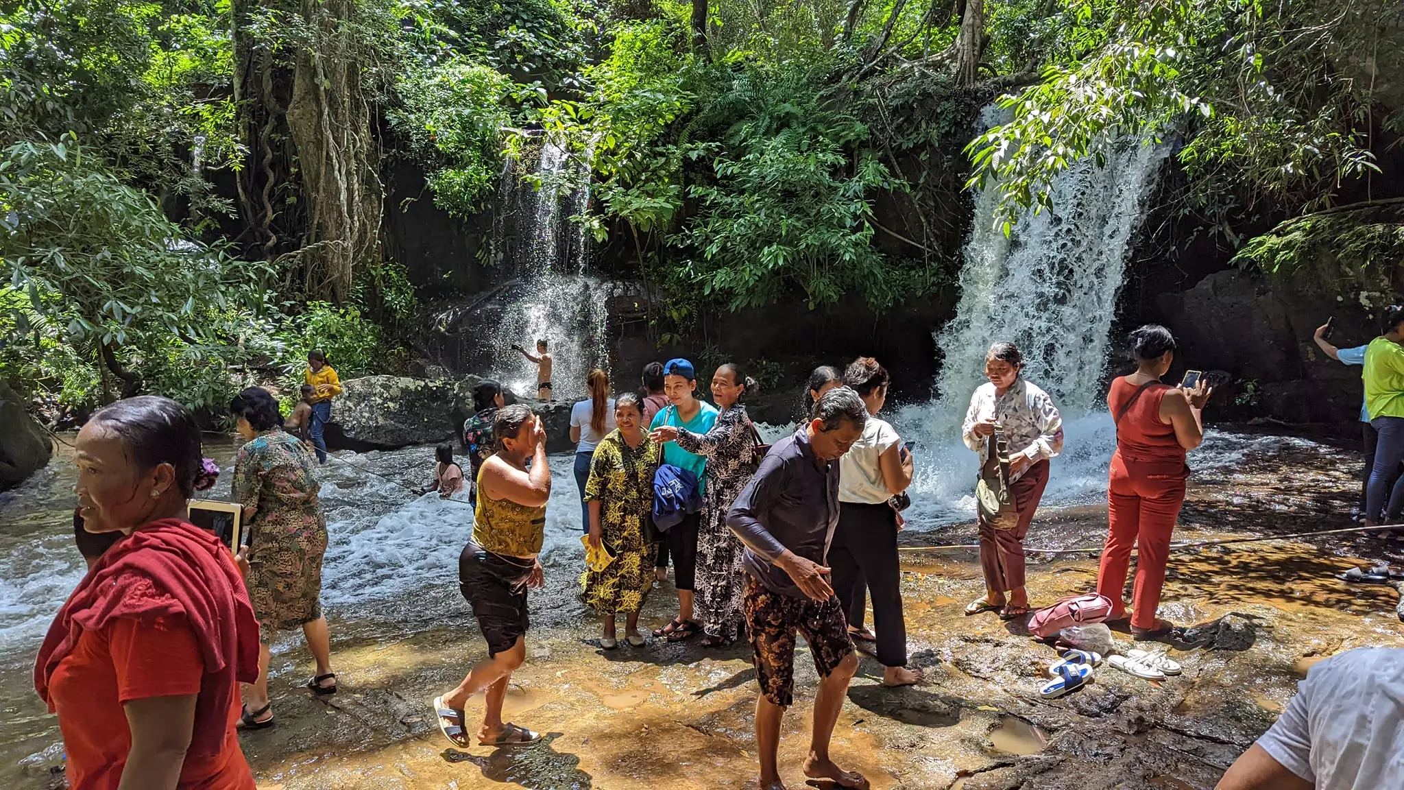 Khmer families cleansing their Karma under the Kbal Spean waterfalls