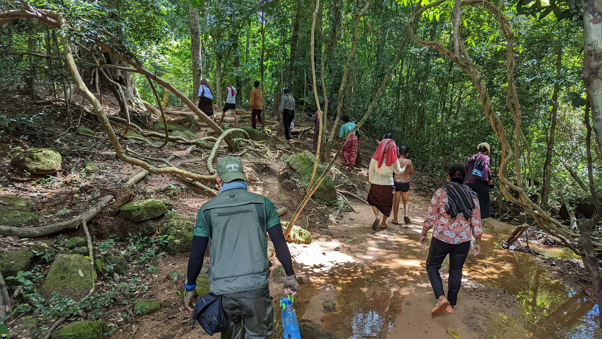 Cambodian families climbing to the Kbal Spean waterfalls to cleanse Karma